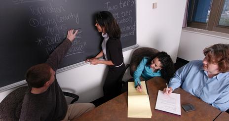 Students doing work on a blackboard